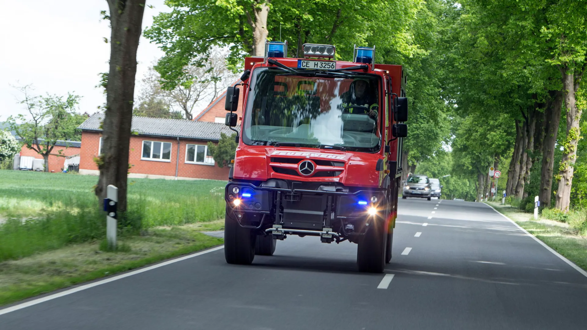 red-mercedes-benz-unimog-on-road